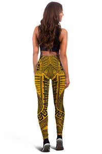 Gold and black tribal leggings, back view, full-length
