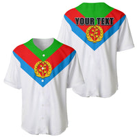 White baseball jersey with green collar, red/blue chevron and gold laurel crest logo