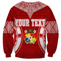 Red unisex sweatshirt with white patterns, your text graphic, and coat-of-arms crest