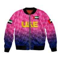 Pink cricket bomber jacket with full zip, black ribbed cuffs, UAE graphic, colorblock sleeves.