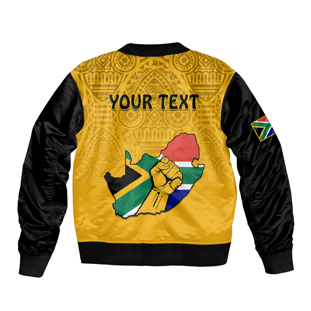 Yellow bomber jacket with black sleeves, back print with South Africa map and hand, text panel