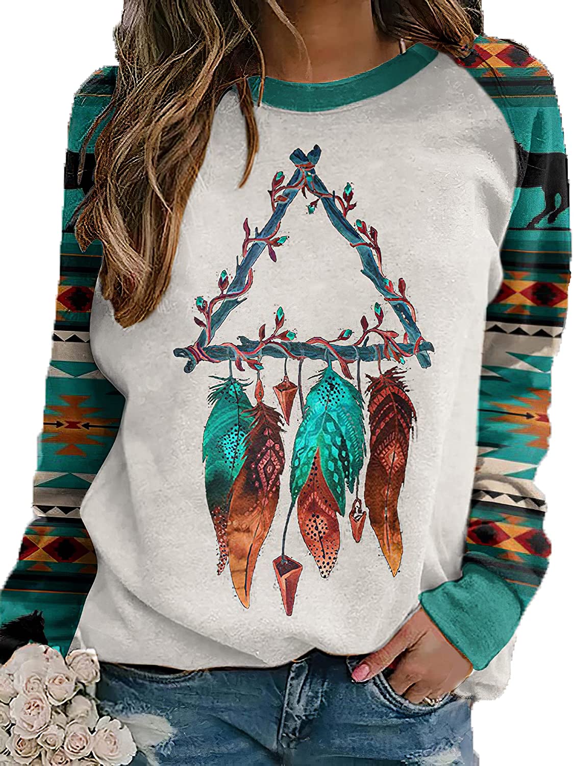 White sweatshirt with multicolor dreamcatcher/feather graphic; tribal striped sleeves
