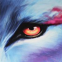 Wolf tapestry eye close-up in black fur with orange glow over blue sky