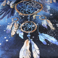 Close-up of blue galaxy dreamcatcher tapestry: round hoop with web design and dangling feathers