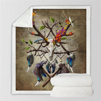 Tribal skull and dreamcatcher feather throw blanket with multicolor accents, folded and shown flat