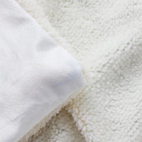 White plush sherpa fabric close-up with raised texture detail