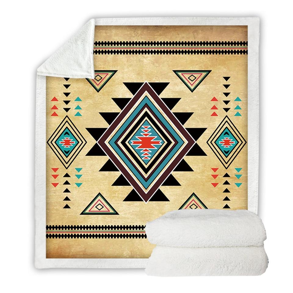 Folded beige geometric blanket with black and teal diamonds, red accents, multicolor border
