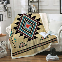 Beige geometric blanket with black, teal, red, and cream Native-style diamond pattern