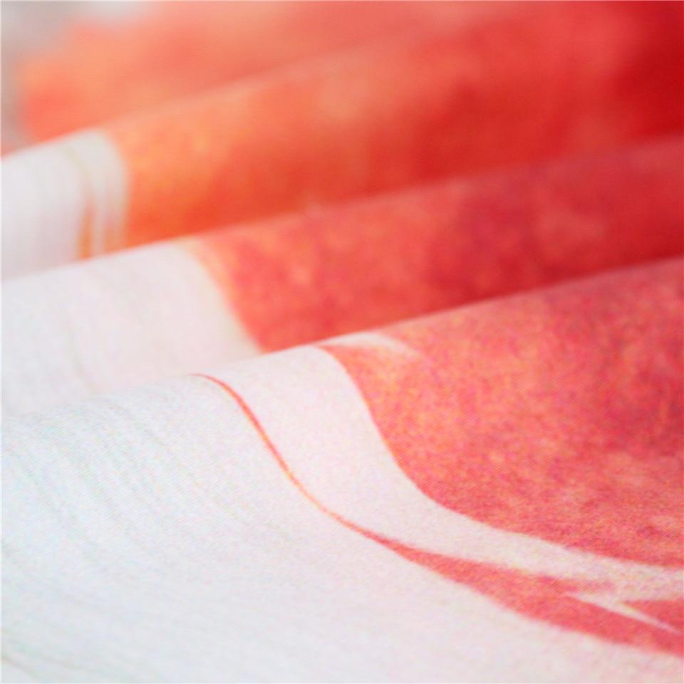 Red-and-pink tapestry fabric detail with curved multicolor design, textured weave