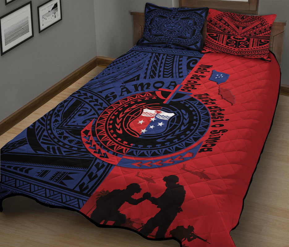 Red and blue quilt bed set with two matching pillows, circular emblem, and tribal prints