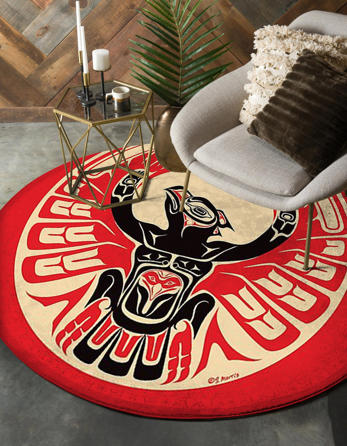 Red round rug with thunderbird graphic in black and cream and beige accents