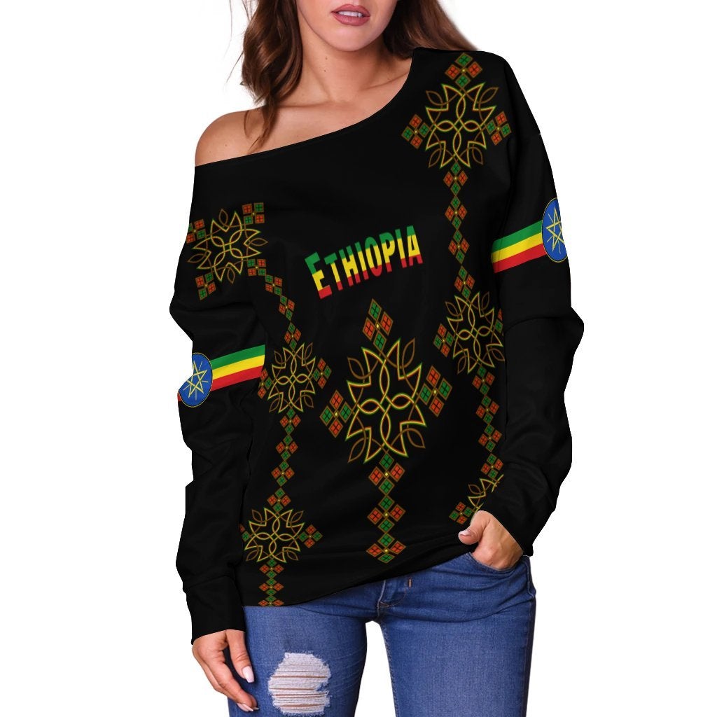 Off-shoulder sweater, black with Ethiopia graphic, diagonal motif, and colorful flags