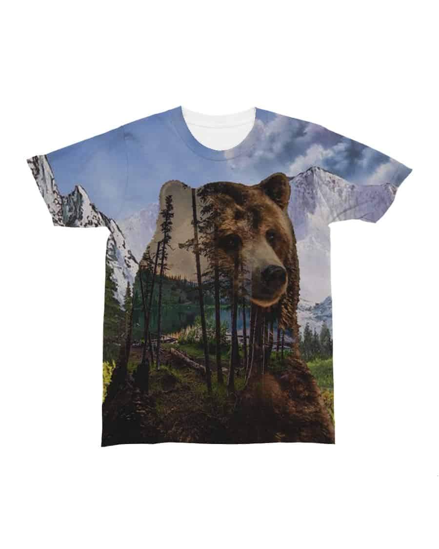 All-over graphic T-shirt with close bear face above pine trees and snowy mountains