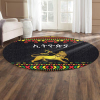 Round dark lion graphic rug with multicolor patterned edge and central script