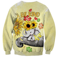 Light yellow sweatshirt back: 'BE KIND' text with elephant, sunflowers, and puzzle pieces