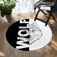 Round black-and-white rug featuring a wolf portrait with large geometric letter shapes