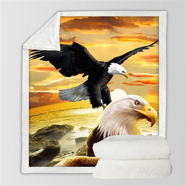 White throw blanket with black eagle in flight beside orange-eyed bald eagle faces