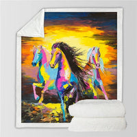 Horses printed throw blanket with colorful paint-style horses on a sunset sky