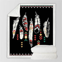 Black feather print blanket with colorful geometric accents and white sherpa reverse