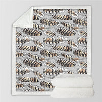 White blanket with leopard-feather pattern and white sherpa backing