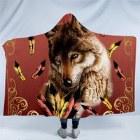 Hooded blanket with brown wolf portrait and yellow feather accents on rust print
