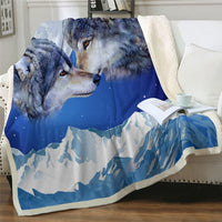 Blue and white wolf print blanket with mountain peaks scene and cream sherpa border