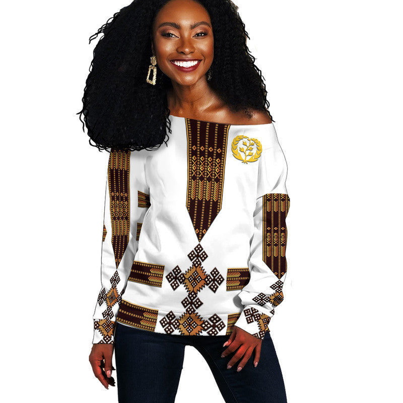 White off-shoulder sweater with Eritrea-style gold-and-black Tibeb pattern, long sleeves
