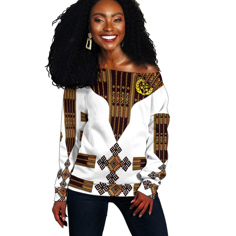 Women off-shoulder sweater in white with Eritrea-style geometric pattern and bold V print